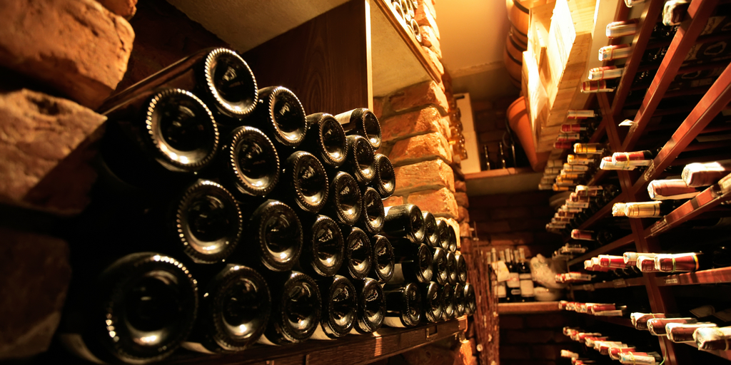 Caviste Club banner showing wine bottles in a cellar.
